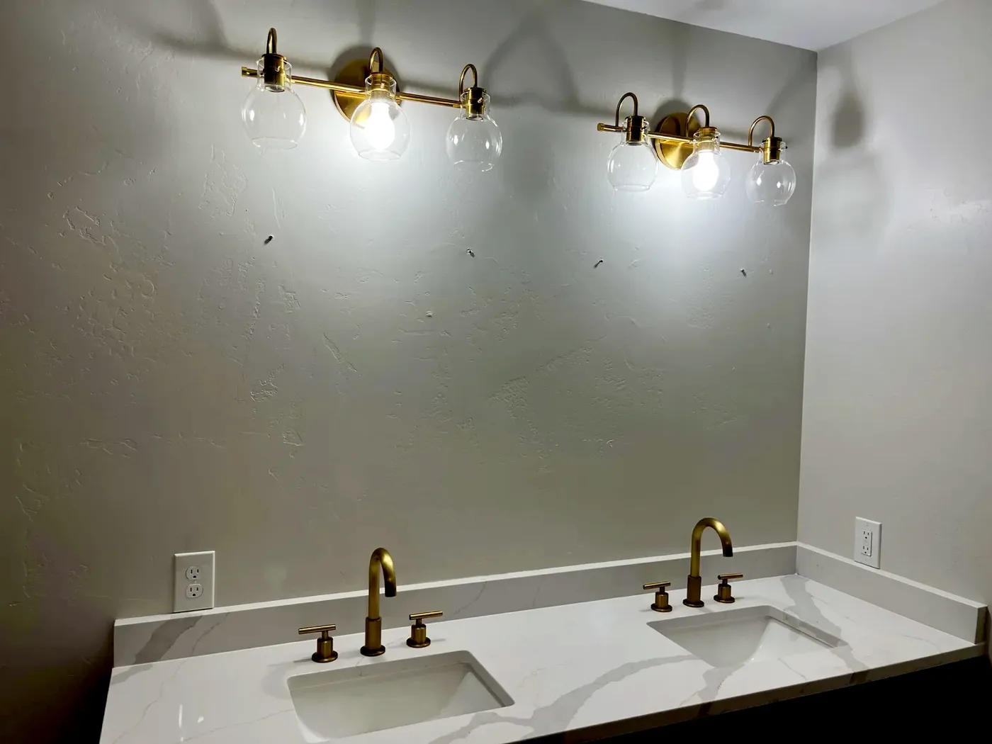 Bathroom vanity with brass lights